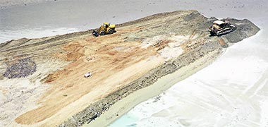 Bulldozers creating the bunds for the New District of Doha