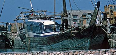 A bus awaiting lifting from a boom, April 1972