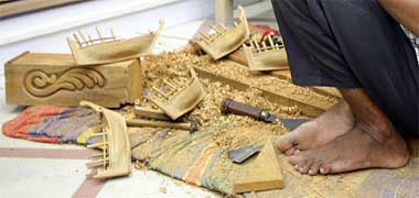 Detail of model dhows being carved