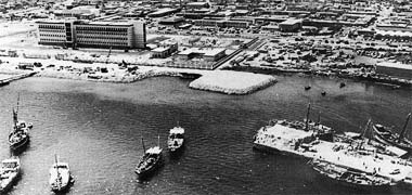 The beginnings of the Corniche and the old port with Government House on the left