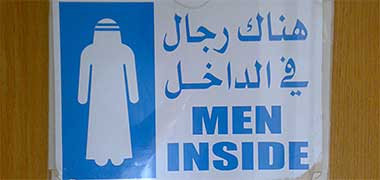 A sign warning of men being behind the door