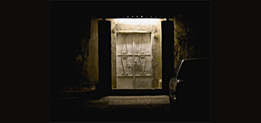 A door, seen by night, in an area of Doha about to be demolished