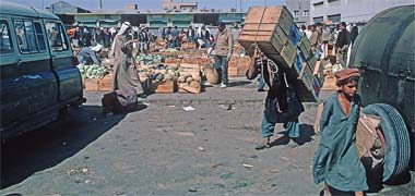 A porter moving crates in the suq, March 1972