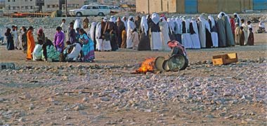 Families gathered at a small razeef