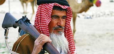 A badawi carrying his rifle