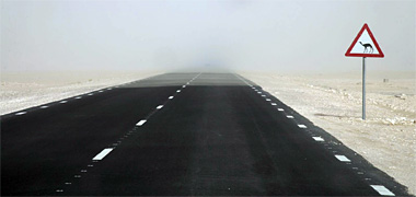 Sand dusting across a road