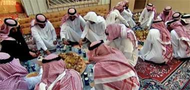 Guests eating a traditional meal in a tent