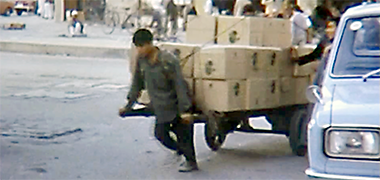 A porter dragging a two-wheeled cart in the suq in the 1960s – developed from a YouTube video