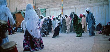 Lines of men and women dancing